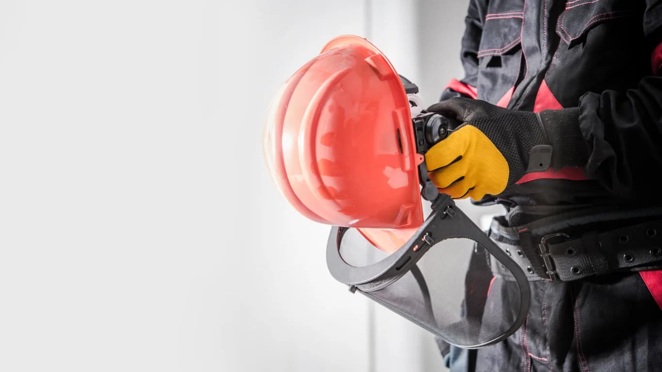 Technician safely removing insulation with PPE and containment setup